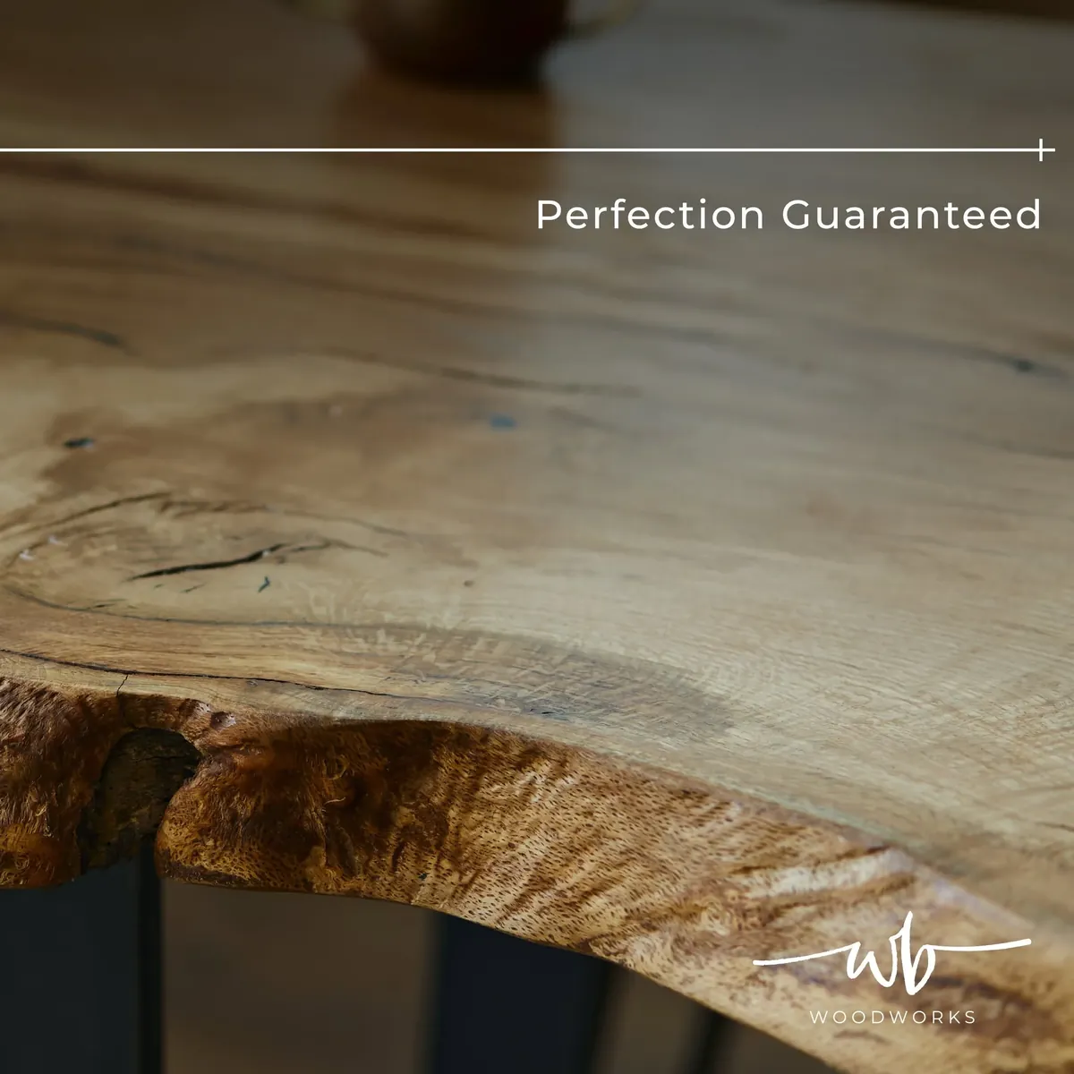Solid wood tabletop with rich grain and a natural live edge above dark legs